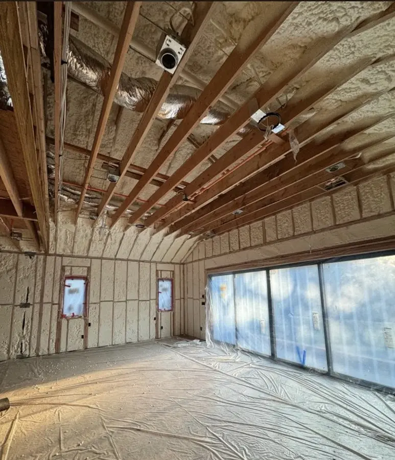Interior walls and ceiling insulated with spray foam during new construction in Welby